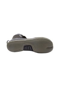 Sole view of a gray and black athletic shoe with textured grip and reinforced heel on a white background.