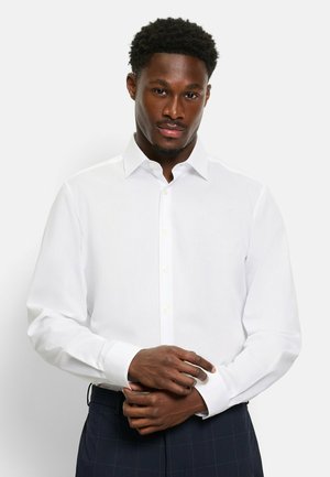 Weißes Langarmshirt aus glattem Stoff mit klassischem Kragen und Knopfverschluss. Mit Knopfmanschetten und taillierter Passform.