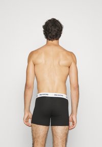 Schwarze Baumwoll-Boxershorts mit einem weißen Bund, der mit dem Branding "ONLY&SONS" versehen ist, von hinten auf einem neutralen Hintergrund betrachtet.