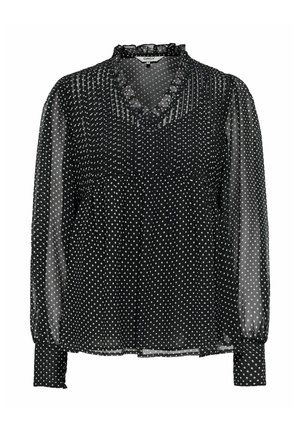 Svart, gjennomsiktig bluse med lange ermer, hvite polkadotter, rysjekantet V-hals og innsydde mansjetter.