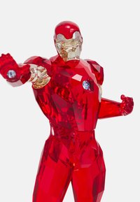 Red crystal figure of a superhero, faceted design, clear and opaque sections, with blue accents on the chest and wrist.