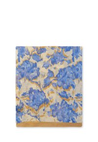 Blue and gold floral-patterned textile with a textured finish. Edges are hemmed in a solid golden-brown color.