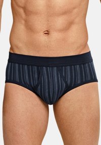 Caleçons pour hommes rayés bleu marine en tissu doux, dotés d'une large ceinture et d'une conception de poche contournée pour un confort optimal.
