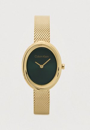 Montre-bracelet Calvin Klein ton or avec un cadran ovale vert et un bracelet en maille, affichant les aiguilles des heures et des minutes réglées à 10h10.