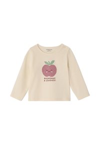 Cremefarbenes Langarmshirt aus weichem Stoff, mit einem grafischen Aufdruck eines lächelnden Apfels mit grünen Blättern und einem Text darunter.