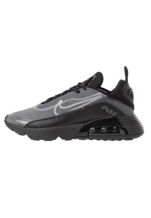 Baskets Nike Air Max noires et grises avec une tige translucide, une semelle à coussin d'air visible et des lacets noirs, vues de profil sur un fond blanc.