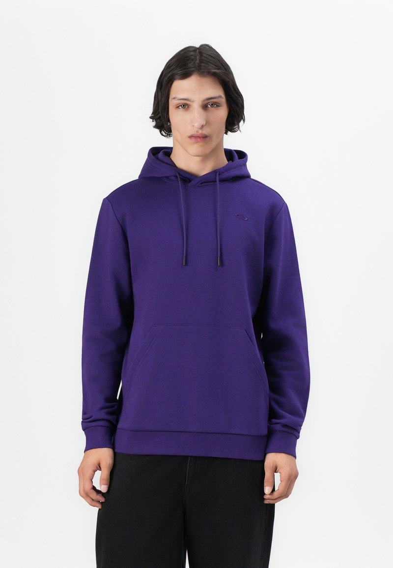 Sudadera morada de tela suave, con un bolsillo canguro, cordones y puños acanalados. Detalle de logo simple en el pecho.