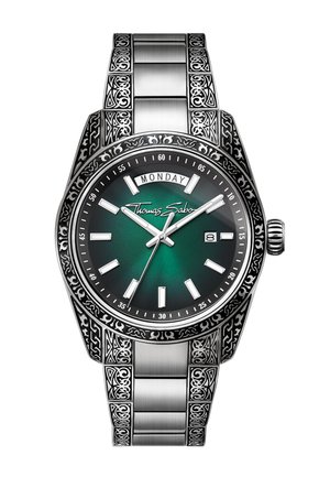 Stainless steel wristwatch with ornate patterns, green dial, white hour markers, day and date windows, and Thomas Sabo logo on the face.