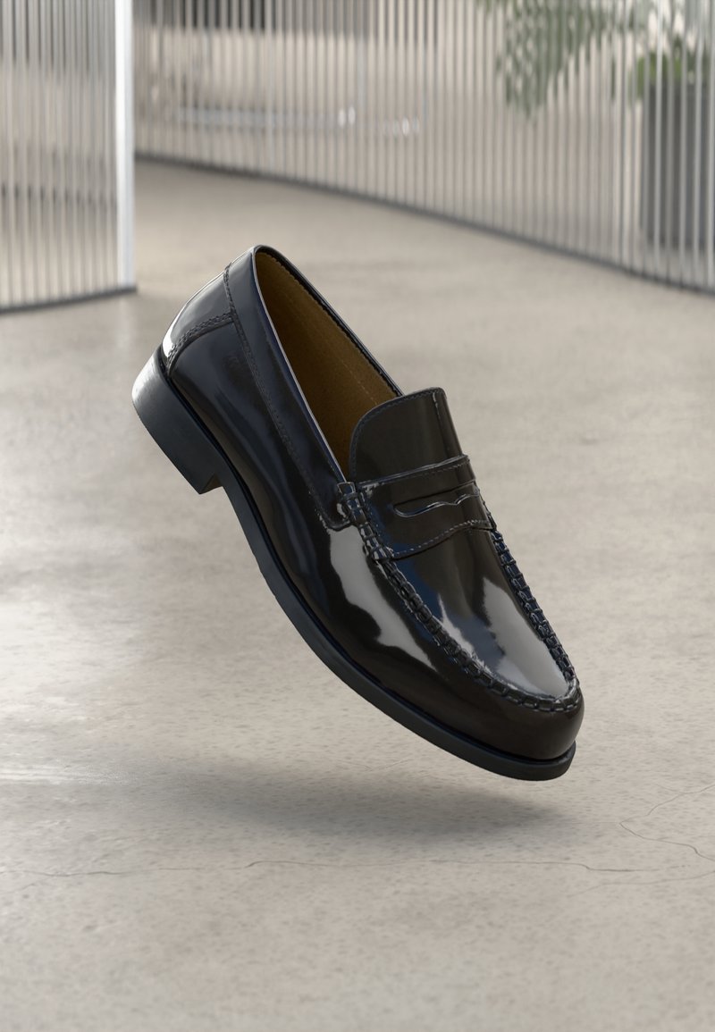 Black patent leather loafer with a stitched accent, round toe, low heel, and smooth surface, displayed against a neutral background.