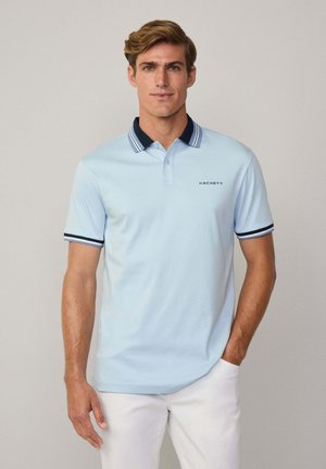 Lysblå polo skjorte med navy krave og stripe detaljer, prydet med et logo på venstre side. Lavet af blødt, åndbart stof.