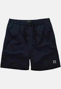 Marineblauwe zwembroek met een elastische tailleband, trekkoordsluiting en wit logo op de onderzoom. Glad, lichtgewicht stof.