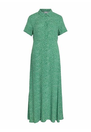 Robe verte à manches courtes, col et boutons sur le devant. Elle présente un motif de pois blancs, fabriquée dans un tissu léger avec un design fluide.