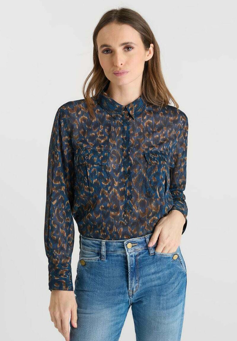 Sheer long-sleeve blouse in dark blue with brown and teal leopard print, featuring a button-down front and two chest pockets.