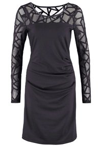 Robe noire longueur genou avec manches longues transparentes et partie supérieure de la poitrine avec motif géométrique en résille.