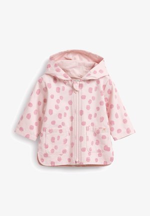 Veste à capuche rose clair avec une fermeture éclair frontale, deux poches latérales et un motif à pois rose foncé. En coton doux.