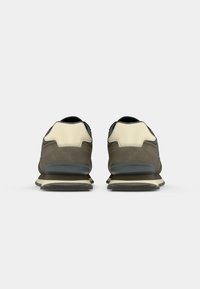 Sport sneakers with a dual-tone upper in brown and cream, textured suede and leather materials, gray soles, and contrasting accents.