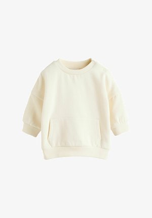 Krém színű pulóver puha anyagból. Bordás mandzsettákkal, kerek nyakkal és elülső zsebével rendelkezik. Egyszerű, laza dizájn.