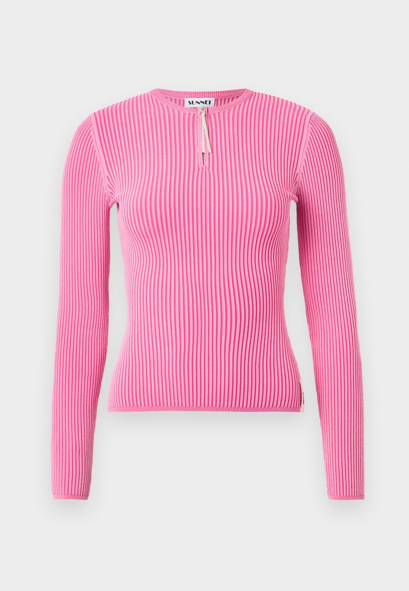 Long-sleeve top in ribbed fabric, bright pink, featuring a round neck with a small zipper and snug fit, textured surface, and side seam detail.
