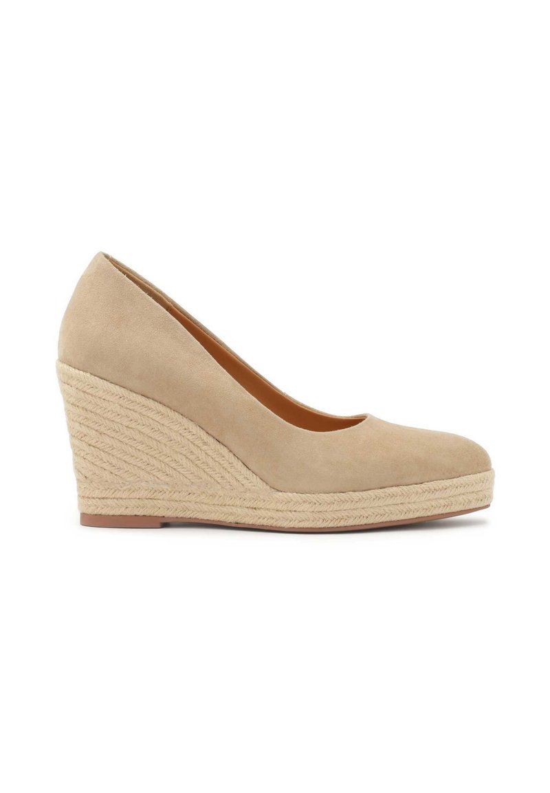 Beige wedge heel shoe with a soft suede upper and braided jute platform. Smooth texture with a rounded toe design and tapered back.