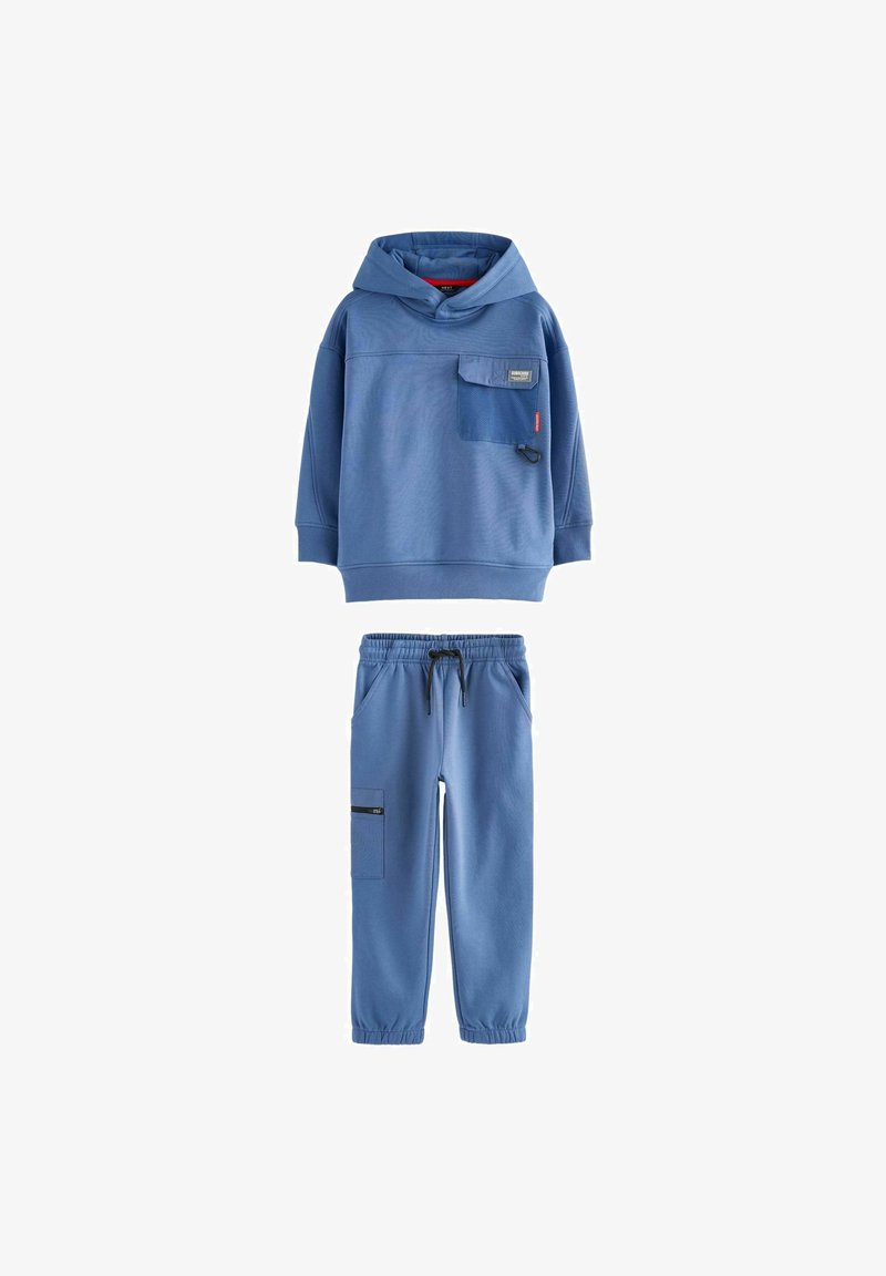Blue sweatshirt with a front pocket, hood, and textured fabric, paired with matching elastic-waist joggers featuring a side pocket.