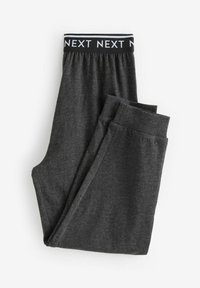 Pantalons de survêtement gris avec une taille élastique noire arborant un texte répétitif "NEXT" en blanc. Tissu doux, design fuselé et poignets côtelés.