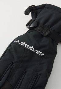 Black waterproof glove with elastic cuff, featuring a logo, textured fabric, stitched seams, and a toggle closure at the wrist.