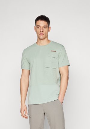 Light green short-sleeve t-shirt made of soft fabric, featuring a chest pocket and a band near the collar with a brand label.