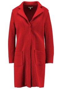 Röd ullrock med långa ärmar, en knäppt krage och två framfickor. Texturerat tyg och knälång design.