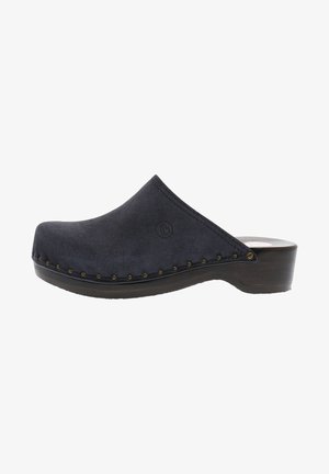 Navy suede clog with a rounded toe, wooden heel, and visible stitching. Decorative brass studs along the sole and brand logo on the side.