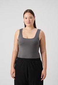 Gray fitted sleeveless top with a square neckline, made from smooth fabric, paired with relaxed black elastic waistband pants.