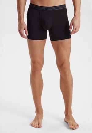 Sorte boxer shorts med tætsiddende pasform, lavet af strækbart stof. Har en blød elastisk kant med "DOVRE" logo. Minimalistisk design.