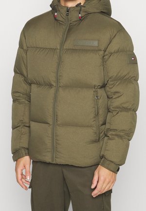 Olive green puffer jacket with hood, front zipper, side pockets, and Hilfiger logo patches on chest and left sleeve.