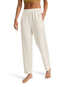 Crème-kleurige, hoge taille broek met een wijde pijp van zachte stof. Voorzien van een elastische tailleband en zijzakken. Gladde textuur, ontspannen pasvorm.