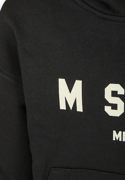 Felpa nera con grandi lettere bianche "M S", con tasca frontale e polsini a coste. Il tessuto è liscio e elasticizzato.
