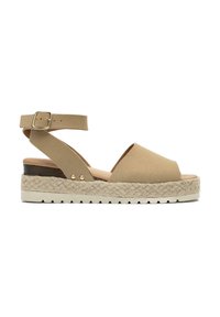 Beige suede platform sandals with a wide toe opening, ankle strap with metallic buckle, natural woven midsole, and textured white rubber sole.