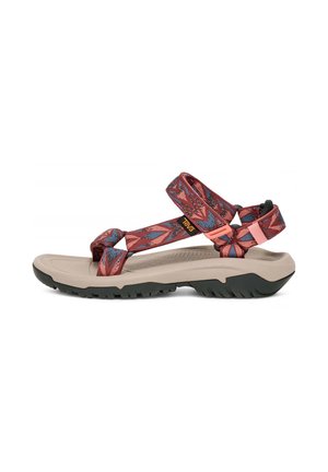 Sport sandals with a beige sole and black traction, featuring multicolored straps in red and blue geometric patterns.