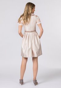Light beige dress with a fitted bodice, pleated skirt, and lace cap sleeves. The waist is accentuated with a satin ribbon.
