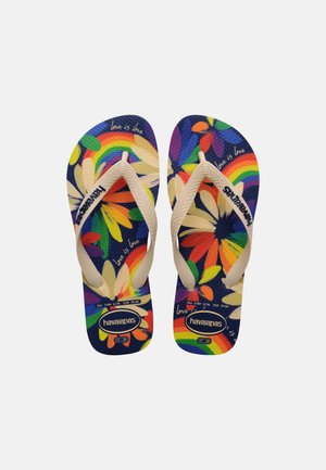 Pair of Havaianas flip-flops with white straps, multicolored floral and rainbow pattern, and "love is love" text on navy blue soles.
