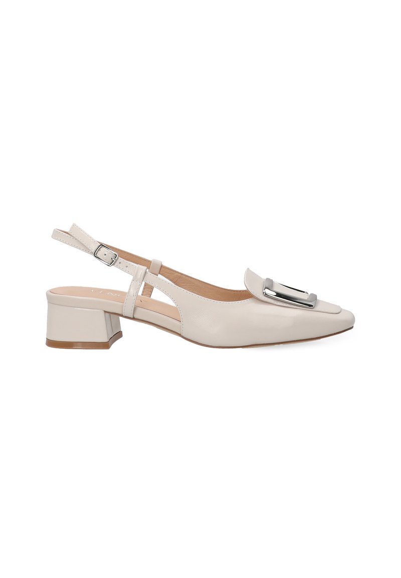 Beige slingback shoe with a pointed toe, glossy finish, low block heel, and decorative silver buckle. Features cut-out design on sides.