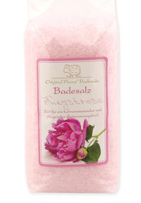 Pink bath salt in a clear plastic packaging, featuring a label with a pink peony illustration and gold accents, on a white background.