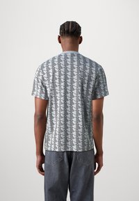 Short-sleeve, light gray t-shirt with a geometric black pattern; crew neck and relaxed fit, made from soft, breathable fabric.