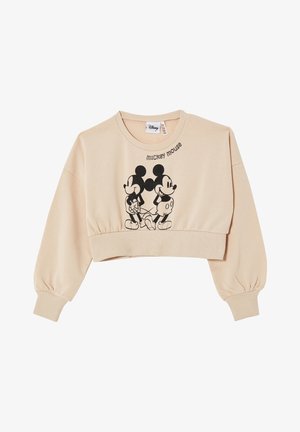 Beskåret beige sweatshirt lavet af blødt stof, med sort Mickey Mouse-grafik og tekst. Ribstrikkede manchetter og kant giver struktur.