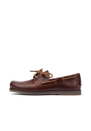 Chaussure bateau en cuir marron avec lacets en cuir beige, coutures moc toe et semelle en caoutchouc, présentée en profil latéral sur fond blanc.