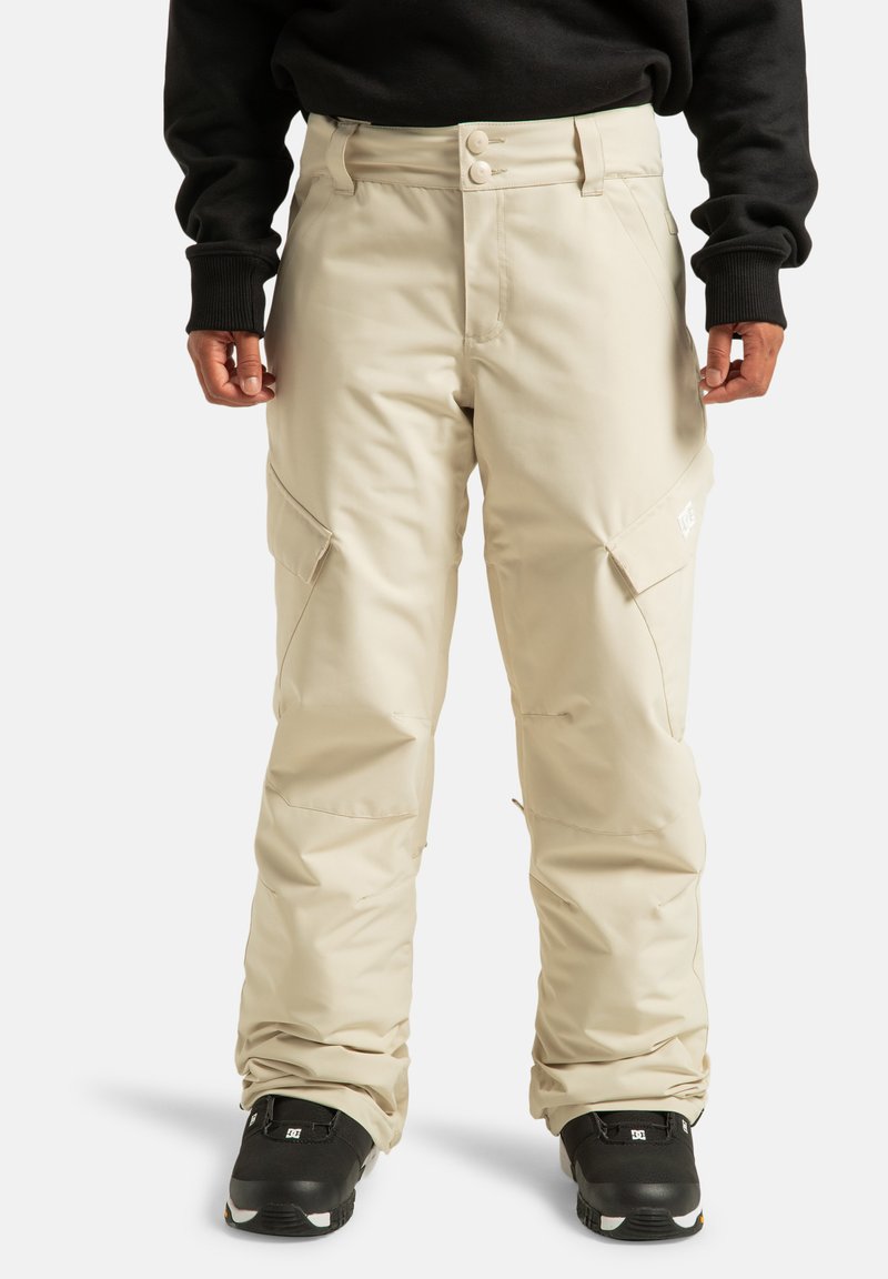 Beige waterdichte sneeuwbroek met een sluiting met twee knopen, zijzakken en een relaxte pasvorm. De stof is glad en duurzaam, geschikt voor koud weer.