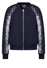 Námořnická bomber bunda s krajkovými rukávy, zipovým zapínáním, žebrovanými manžetami a lemem. Měkká tkanina s kontrastním strukturovaným krajkovým detailem.