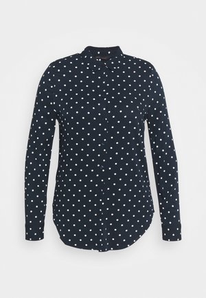 Granatowa koszula z długim rękawem na guziki z białymi grochami i szpiczastym kołnierzykiem.