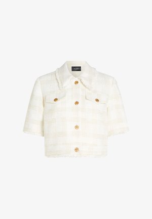 Veste blanche courte en tissu texturé avec un motif à carreaux. Comprend un col, des manches courtes et des accents de boutons dorés.