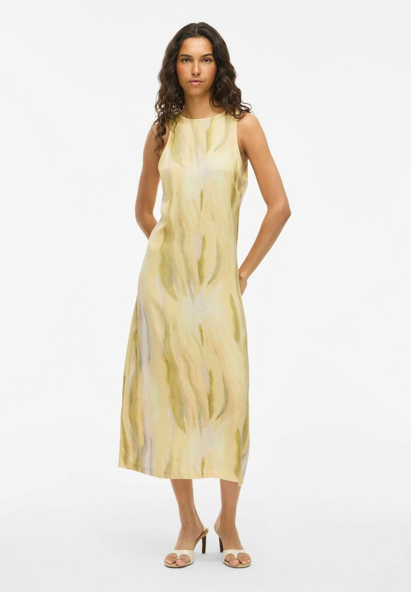 Sleeveless midi dress in light yellow with abstract green and beige patterns. Smooth texture with a relaxed fit and side pockets.