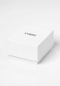 Weißer quadratischer Karton mit Deckel, der ein minimalistisches Design aufweist. Der Markenname "CHRIST" ist in Schwarz auf der Oberseite gedruckt.