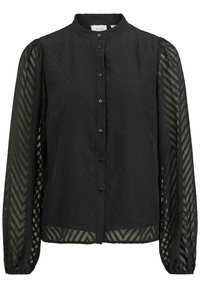 Blouse noire à col montant, présentant un motif en zigzag texturé, fermée par des boutons, avec des manches transparentes à motifs.